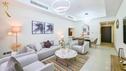 a living room with a couch and a table at 2BR Waterfront Lamar Residences Abu Dhabi in Al Qurayyah