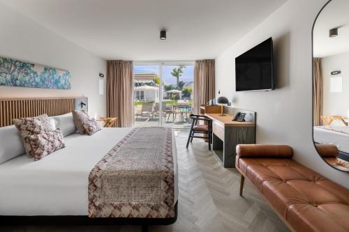 a hotel room with a bed and a couch at TUI BLUE Atlantic Hills in Puerto de la Cruz