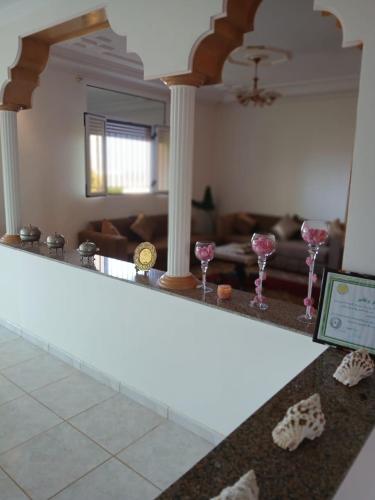 a living room with wine glasses on a counter at Kariat arkma in Nador