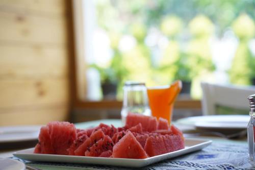 a plate of sliced watermelon on a table at Megha Resort & Villas, Dehradun-Where Nature Pampers You in Dehradun