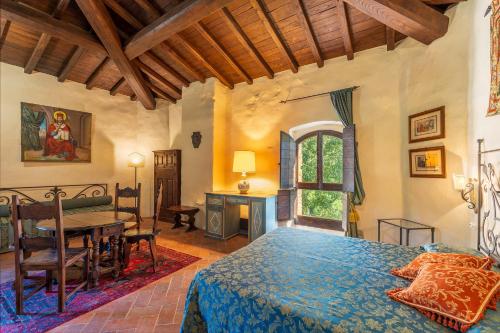 a bedroom with a bed and a table in it at Tuscany Tower Villa in Capolona