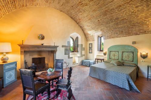a bedroom with a bed and a fireplace at Tuscany Tower Villa in Capolona
