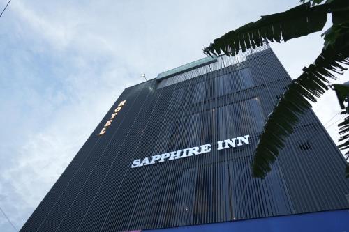 a building with a sign on the side of it at Sapphire Inn in Haldwāni