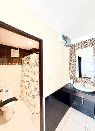 a bathroom with a toilet and a sink at Thai Classic House in Patong Beach