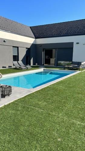 a swimming pool in the backyard of a house at Midnight Villa in Cerkvenjak