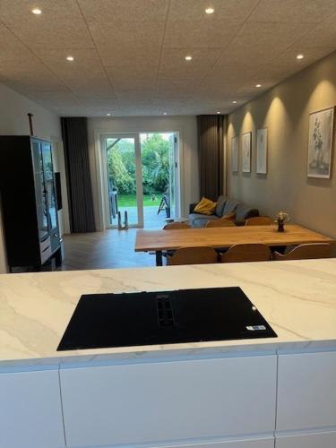 a room with two tables and a living room at Stue villa lejlighed med adgang til stor have in Herning