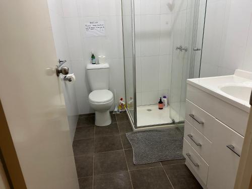 a bathroom with a shower and a toilet and a sink at Room in Fawkner in Melbourne