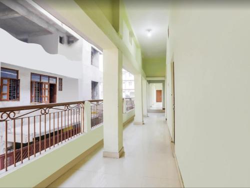 an empty corridor of a building with a balcony at The Vinayaka Guest House in Dānāpur