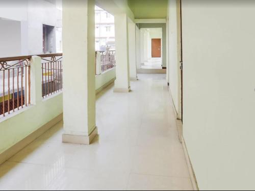 an empty hallway with columns in a building at The Vinayaka Guest House in Dānāpur
