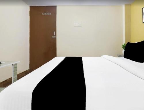 a black and white bed in a room at The Vinayaka Guest House in Dānāpur