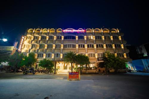 a large building with lights on top of it at night at New Hotel Broadway in Varanasi
