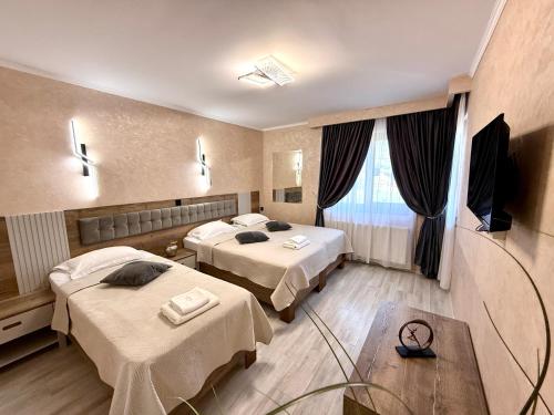 a hospital room with two beds and a table at Hotel Dorobanti in Iaşi