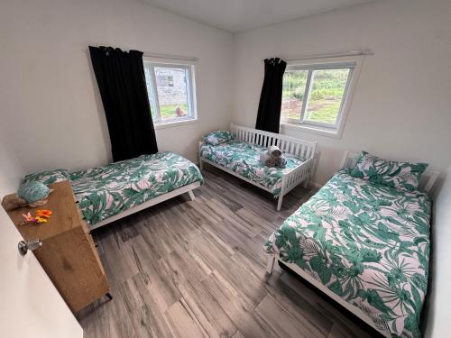 Llit o llits en una habitació de Te Kopa Villa