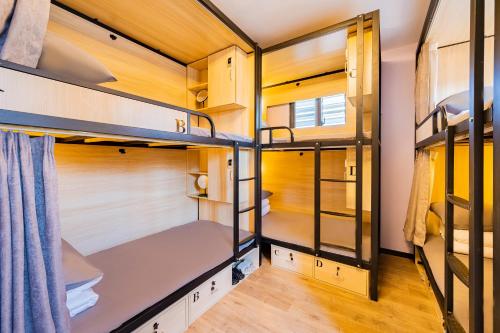 a group of bunk beds in a tiny house at BeiJing Seeyou Hostel -Close to the city center Near Subway Line 10 Sanyuanqiao,Close to Sanlitun,Yonghe Lama Temple,Tourism service in Beijing