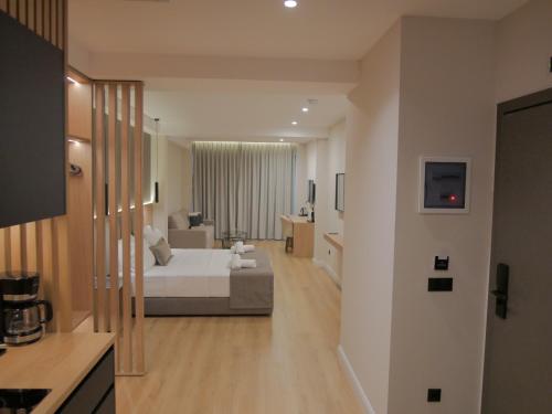 a hotel room with a bed and a living room at JKB Panoramic Suites in Athens