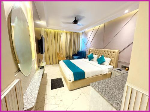 a hotel room with a bed and a mirror at Hotel Dreamland - Fully Air Conditioning Luxuary Rooms - Lift - Restaurant & Parking Facilitie-A Top Rated Four Star Hotel in Bodh Gaya