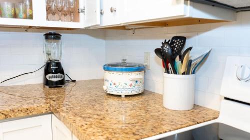 a kitchen counter with a jar of utensils on it at Surfside II #109 home in Coffeyville