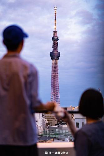 a group of people looking at the eiffel tower at Apartment Hotel 11 Asakusa 2 in Tokyo