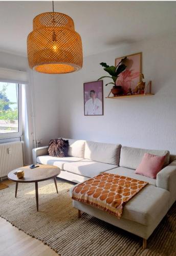 a living room with a white couch and a table at Apartment Relax in Copenhagen