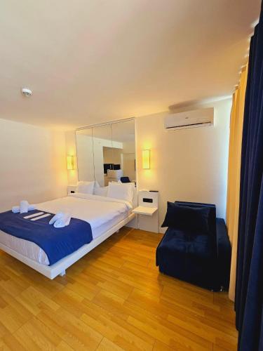 a bedroom with a large bed and a mirror at Orbi City Luxury SUITE in Batumi