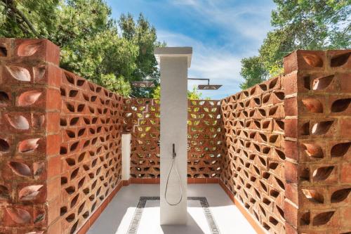 a wooden fence with a white column on a patio at Excelsior Palace Hotel in Taormina