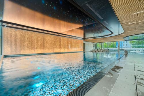 a large swimming pool in a building at Your Holidays Waves Panorama D866 in Międzyzdroje