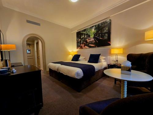 a hotel room with a bed and a couch at Dancenter Boutique Luxury Gatwick Airport in Dorking