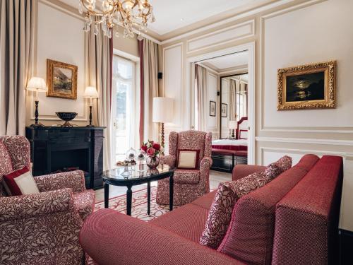 a living room with a couch and a table at Hotel Sacher Salzburg in Salzburg