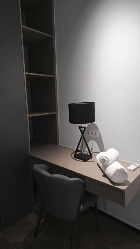a desk with a chair and a lamp on it at Hermanos Apartments 702 in Shëngjin