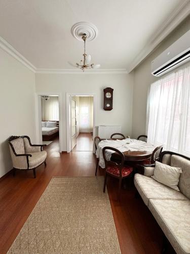 a living room with a table and a couch at Garden House Heybeliada in Adalar