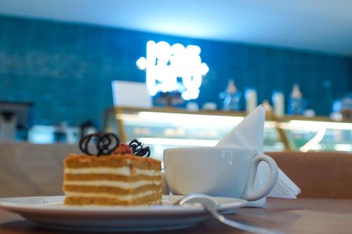 a piece of cake and a cup of coffee on a table at Best Western Plus Jeddah Hotel Madinah Road in Jeddah