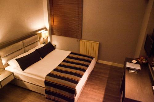 Postel nebo postele na pokoji v ubytování The New Hotel Zeybek