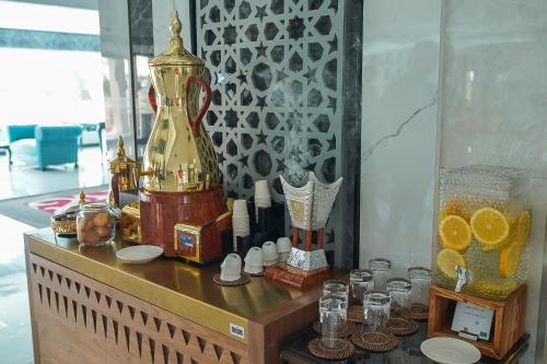 a table with a vase and other items on it at Best Western Plus Jeddah Hotel Madinah Road in Jeddah