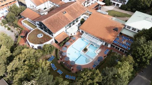 an overhead view of a house with a swimming pool at Hotel Das Ludwig in Bad Griesbach