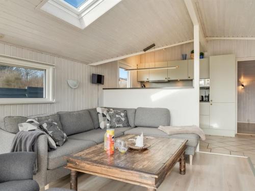 a living room with a couch and a table at Holiday Home Gorjana - 500m from the sea by Interhome in Hjørring