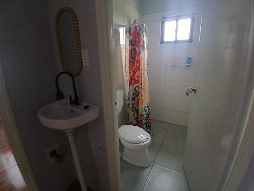 a small bathroom with a toilet and a sink at Maitidi Place in Paramaribo