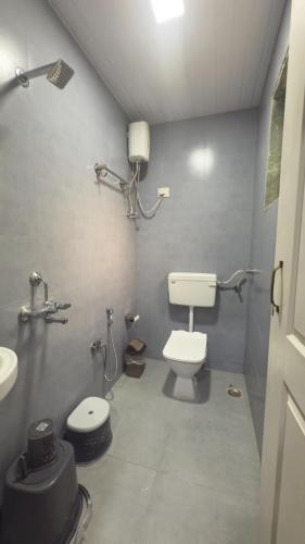 a bathroom with a toilet and a sink at Magnolia Fields in Neral