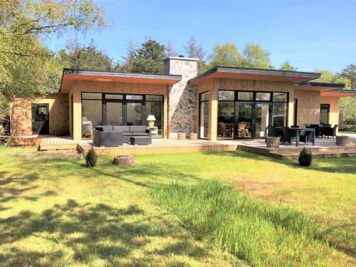 a house with a large patio and a yard at Holiday Home Sune - 175m from the sea by Interhome in Nykøbing Sjælland