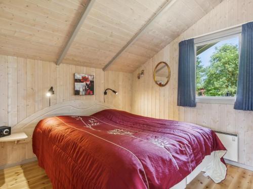 a large bed in a room with a window at Holiday Home Dorti - 725m from the sea by Interhome in Nyrup