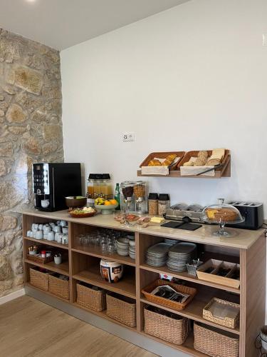 a kitchen with a counter with food on it at Palacium Charming Suites in Figueiró dos Vinhos