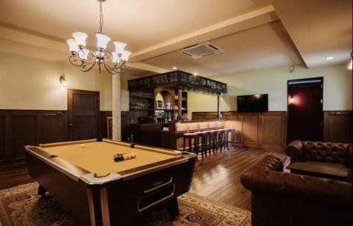 a living room with a pool table and a bar at Palm Villa - Award Winning Modern Luxury & Exclusive Villa in Chiang Mai