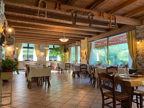 a dining room with tables and chairs in a restaurant at Hotel della valle in Vernante