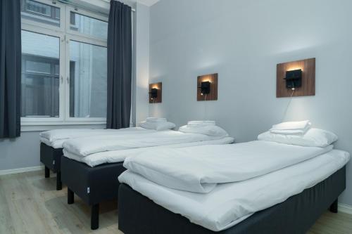 Ένα ή περισσότερα κρεβάτια σε δωμάτιο στο MAYA Apartments - Sentrum