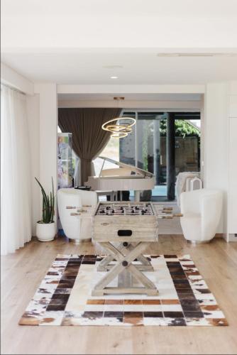 a living room with a piano and a table at Palm Villa - Award Winning Modern Luxury & Exclusive Villa in Chiang Mai