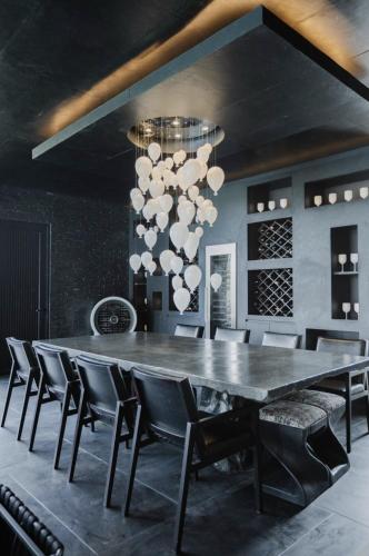 a dining room with a large table and chairs at Palm Villa - Award Winning Modern Luxury & Exclusive Villa in Chiang Mai