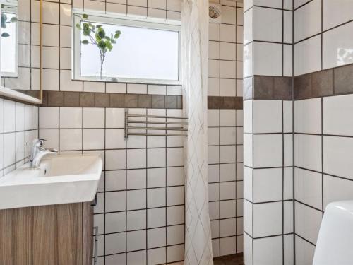 a bathroom with a sink and a window at Holiday Home Dome - 12km from the sea by Interhome in Rønde