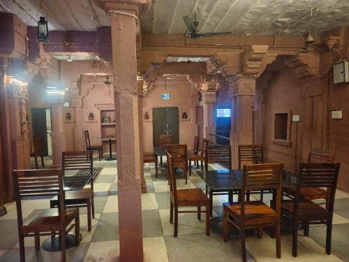 a dining room with wooden tables and chairs at Shikhar Niwas in Jodhpur