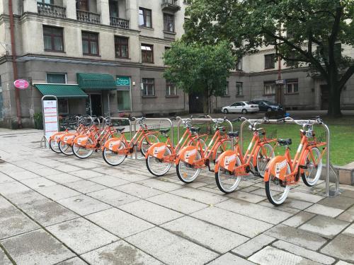 a row of orange bikes parked in a row at Luxury Dana's City Centre Apartment in Kaunas