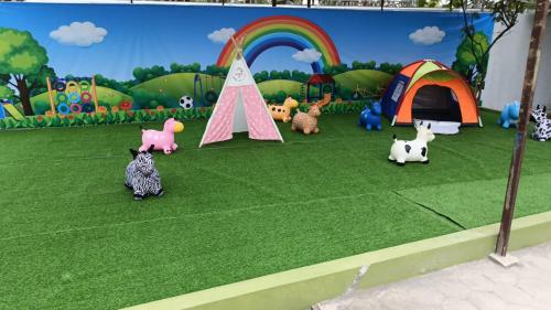 a group of toy animals in a field with tents at H & R Villa Yogyakarta in Manisrenggo