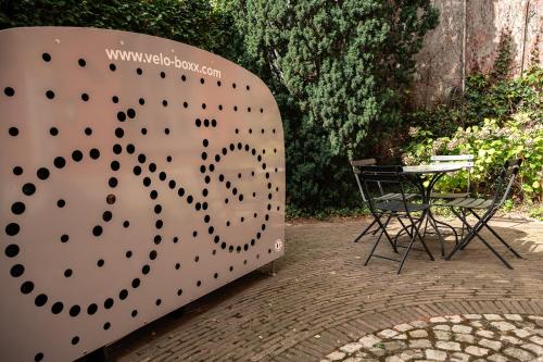 a large metal structure with a table and chairs at Quiet and cosy apartment near the city center of Diest in Diest